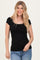 woman wearing a black ribbed short sleeve top and blue jeans