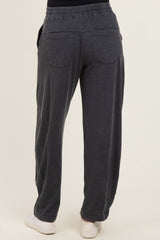 woman wearing dark gray relaxed fit sweatpants with pockets and a comfortable waistband, seen from the back