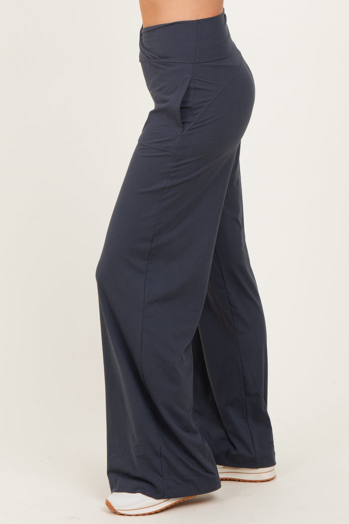 woman wearing navy wide-leg pants with a high waistband and a relaxed fit