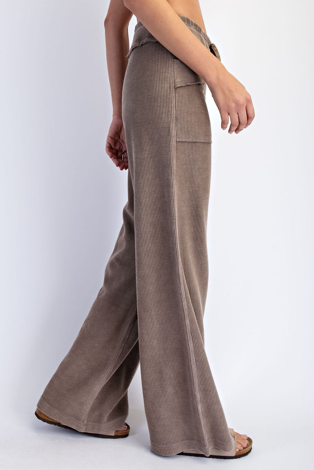 woman wearing brown ribbed wide-leg pants with pockets, styled casually
