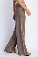 woman wearing brown ribbed wide-leg pants with pockets, styled casually