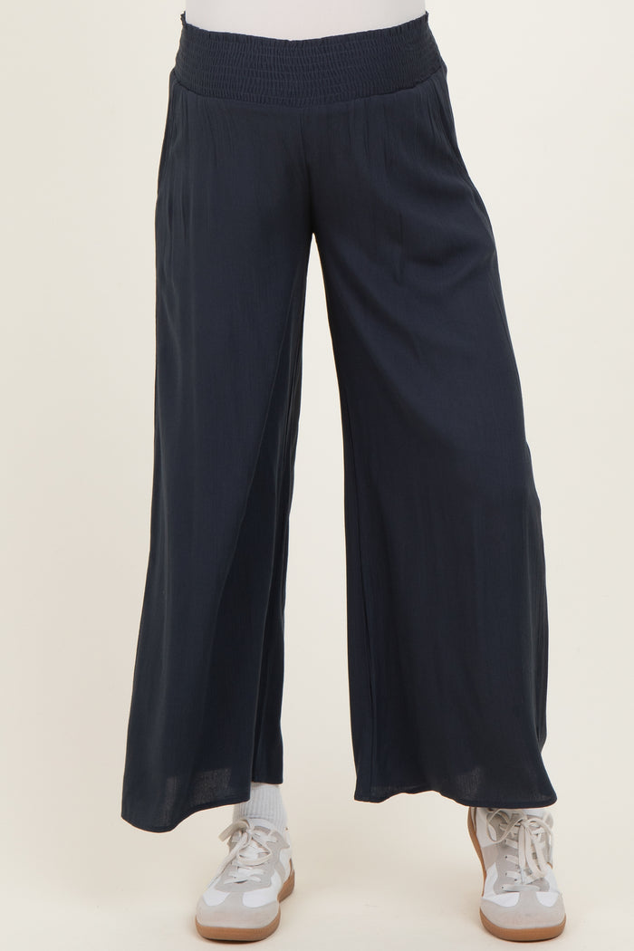 navy blue wide-leg maternity pants with a smocked waistband, paired with white sneakers and socks