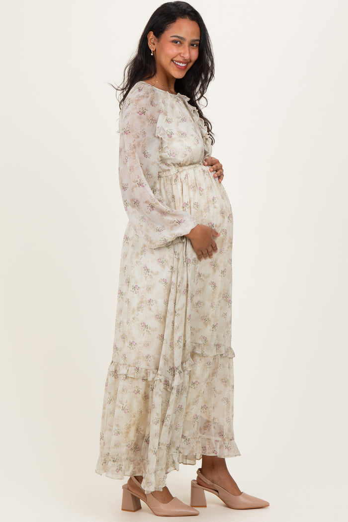 woman wearing a floral long sleeve maternity dress with a relaxed fit and ruffled hem, showing her baby bump