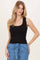 woman wearing a black ribbed tank top with a scoop neckline and styled with light blue high-waisted pants