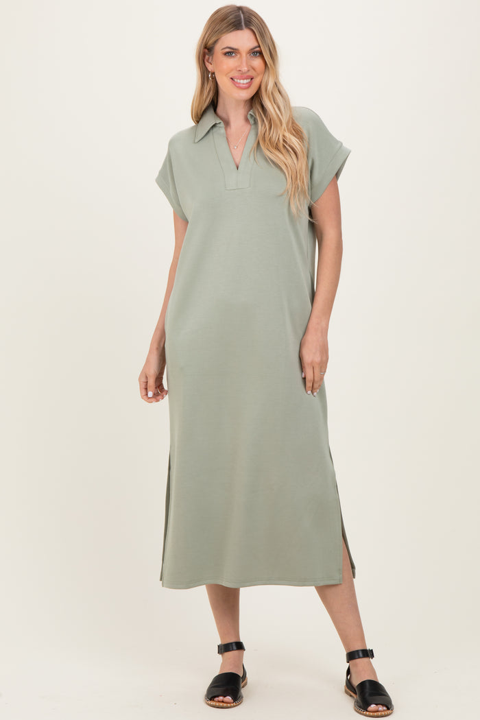 woman wearing a light green short sleeve collared maxi dress with side slits and black sandals