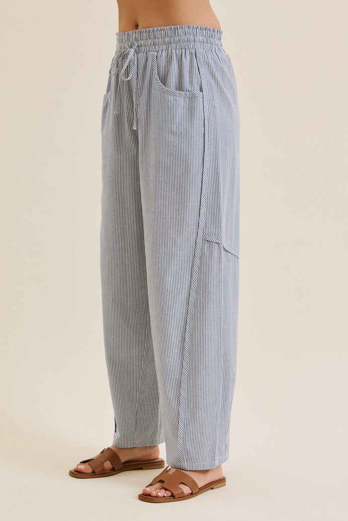 woman wearing blue and white striped wide-leg pants with an elastic waistband and side pockets