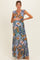 woman wearing a floral maternity maxi dress with ruffled sleeves and holding her baby bump
