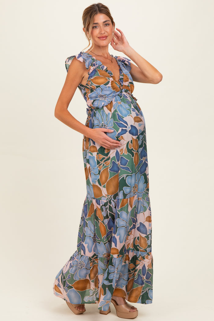 woman wearing a floral print maternity maxi dress with ruffled sleeves and a visible baby bump