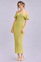 woman wearing a light green off-shoulder ribbed midi dress with ruffle details and a drawstring neckline
