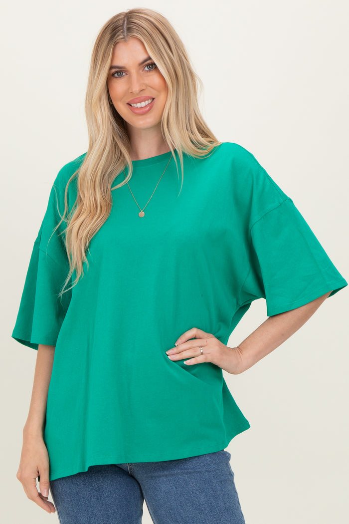woman wearing a bright green oversized t-shirt with short sleeves and relaxed fit