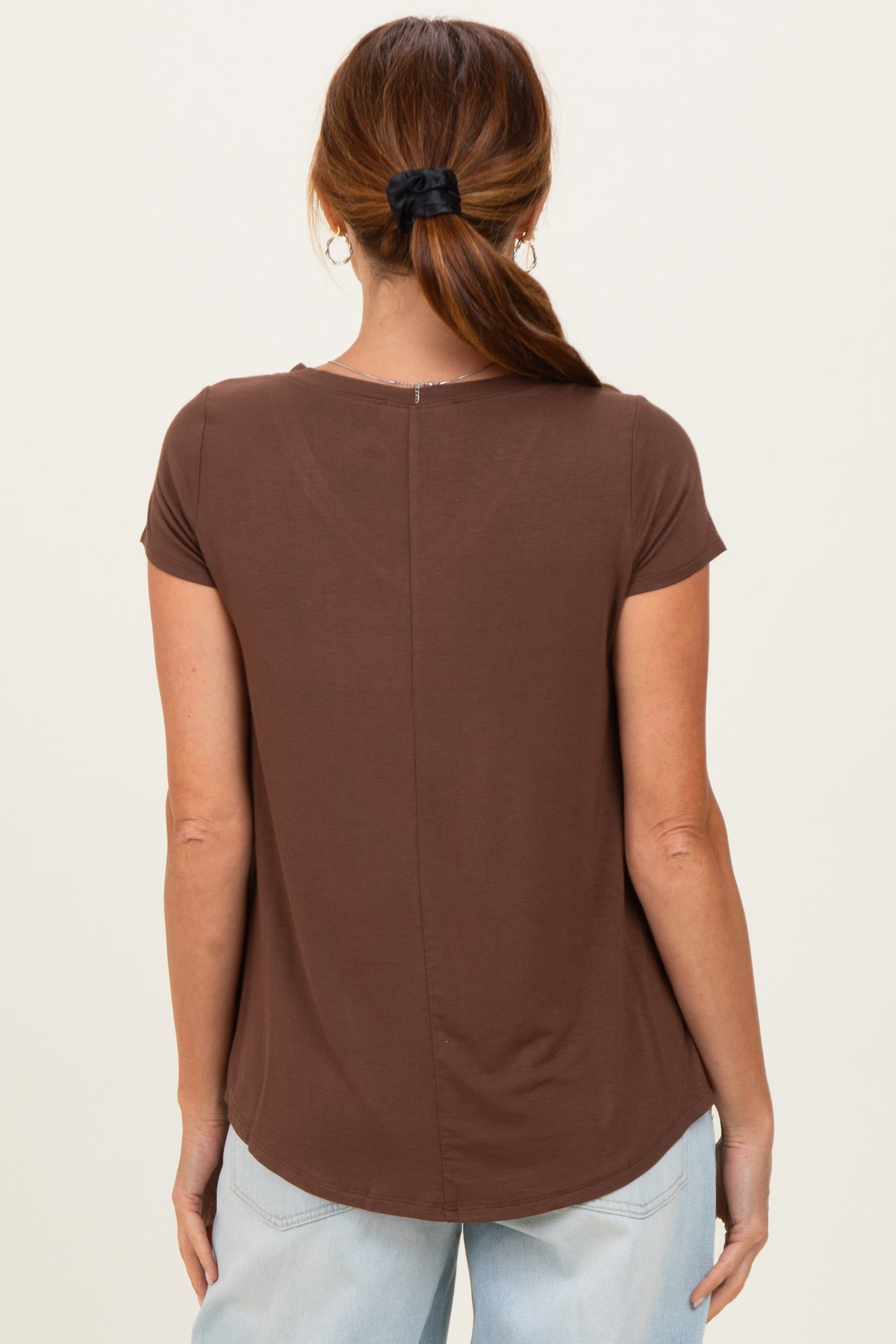 woman wearing a brown short sleeve t-shirt with a relaxed fit and a back seam detail