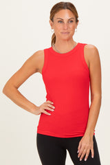 woman wearing a red sleeveless ribbed tank top and black leggings