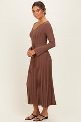 woman wearing a brown ribbed long sleeve maxi dress with a tie waist and flared sleeves