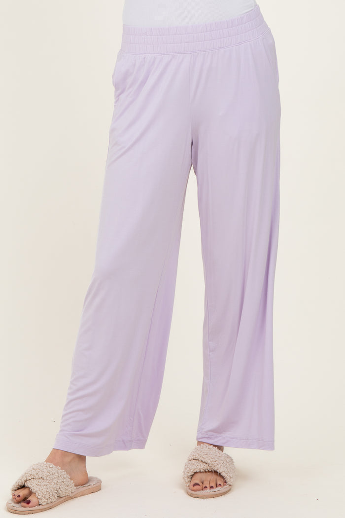 woman wearing light purple wide-leg lounge pants and cozy slippers