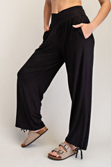 woman wearing black wide-leg pants with pockets and an elastic waistband
