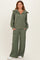 woman wearing a sage green zip-up hoodie and wide-leg pants set with long sleeves and pockets