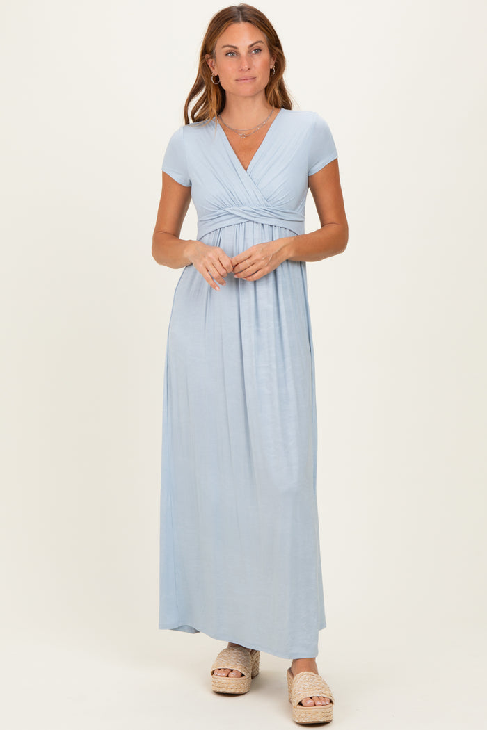 woman wearing a light blue short sleeve maxi dress with a v-neck and gathered waist detail