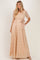 woman wearing a beige lace maxi dress with short sleeves and a tied waist sash