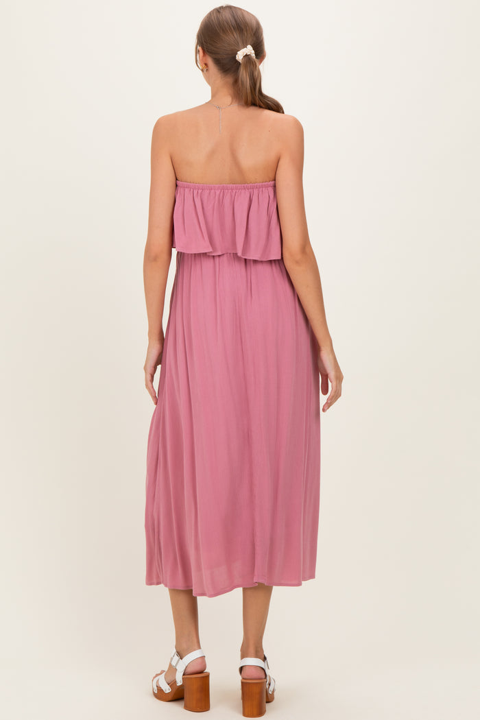 woman wearing a mauve strapless maternity dress with a tiered ruffle detail, showing a relaxed fit and flowy silhouette