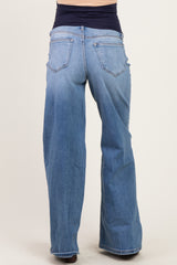 woman wearing light blue maternity wide-leg jeans, showcasing the back view with a stretchy waist panel