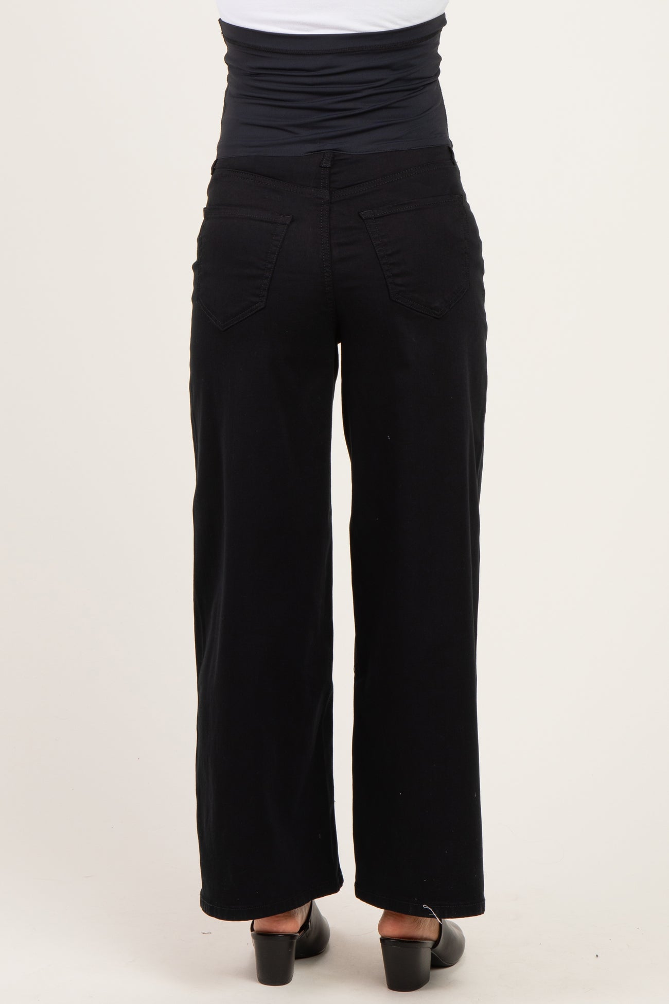 woman wearing black wide-leg maternity pants, showing the back view and a supportive waistband