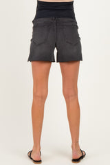 woman wearing black maternity shorts with a stretchy waistband, showing a fitted style from the back