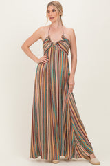 woman wearing a multi-colored patterned maxi dress with a halter neck style and flowy silhouette