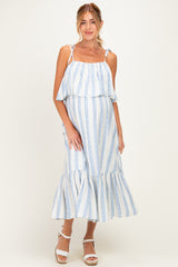woman wearing a white and blue striped maternity dress with a layered ruffle detail and a flowy hem, showcasing her baby bump