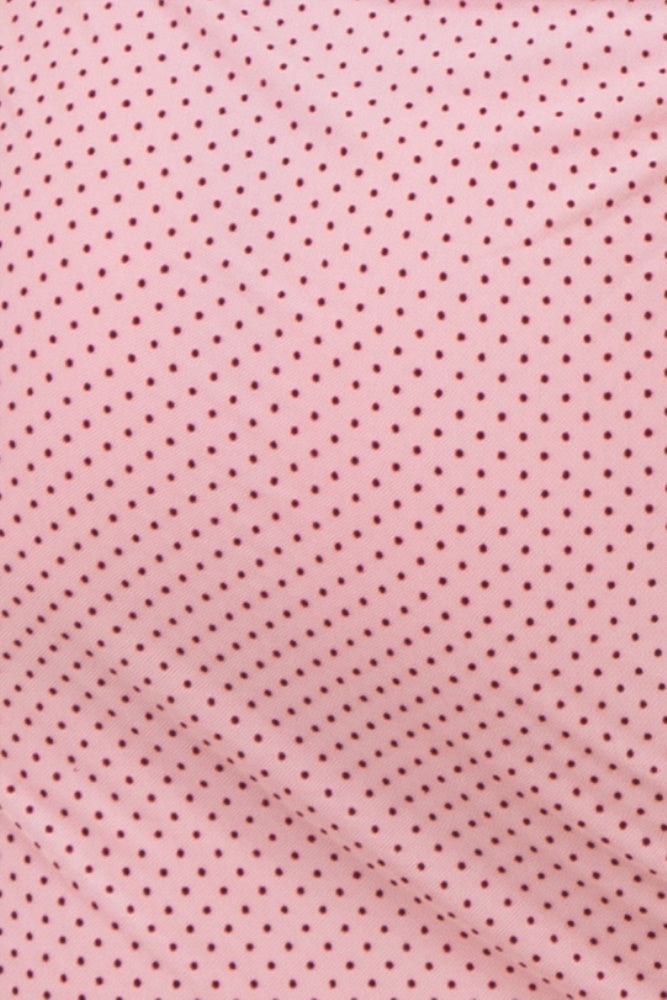 close-up of a pink fabric with small maroon polka dots