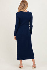 woman wearing a navy blue ribbed long sleeve maternity dress, showing the back view