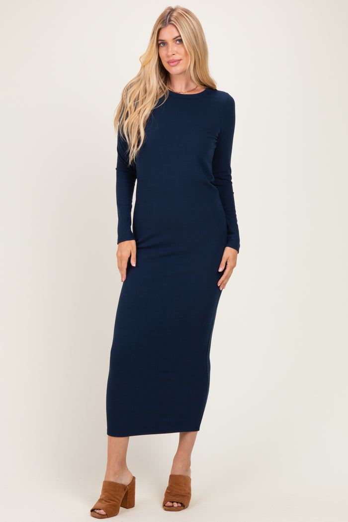 woman wearing a navy ribbed long sleeve maxi dress and brown heeled sandals