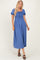 woman wearing a blue smocked maxi dress with puff sleeves and a tie detail at the neckline