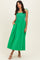 woman wearing a bright green maxi dress with a smocked bodice and adjustable straps, featuring side pockets