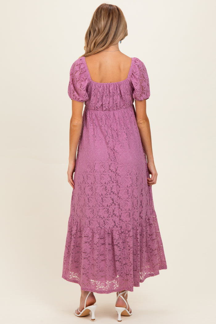 woman wearing a lavender lace maternity maxi dress with short puff sleeves and a tiered hem, showing a baby bump