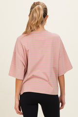 woman wearing a light pink striped maternity top with short sleeves and a relaxed fit, seen from the back