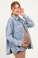 woman wearing a light blue oversized denim jacket, showcasing her baby bump in a fitted brown dress underneath