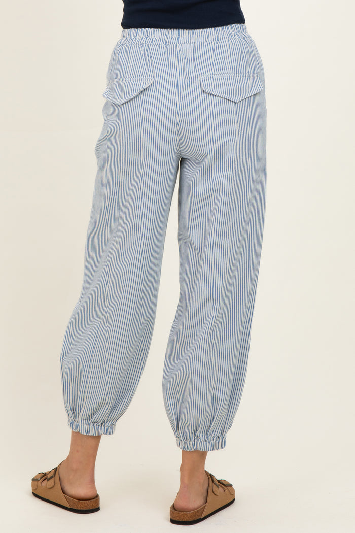woman wearing light blue striped jogger pants with elastic waistband and cuffed ankles, showing back view