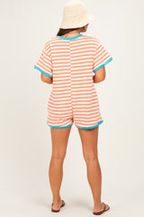 woman wearing a striped maternity romper in orange and blue, featuring short sleeves and a casual fit.