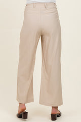 woman wearing light beige wide-leg maternity pants, viewed from the back