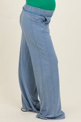 woman wearing soft blue maternity lounge pants with a side pocket and relaxed fit, highlighting a baby bump