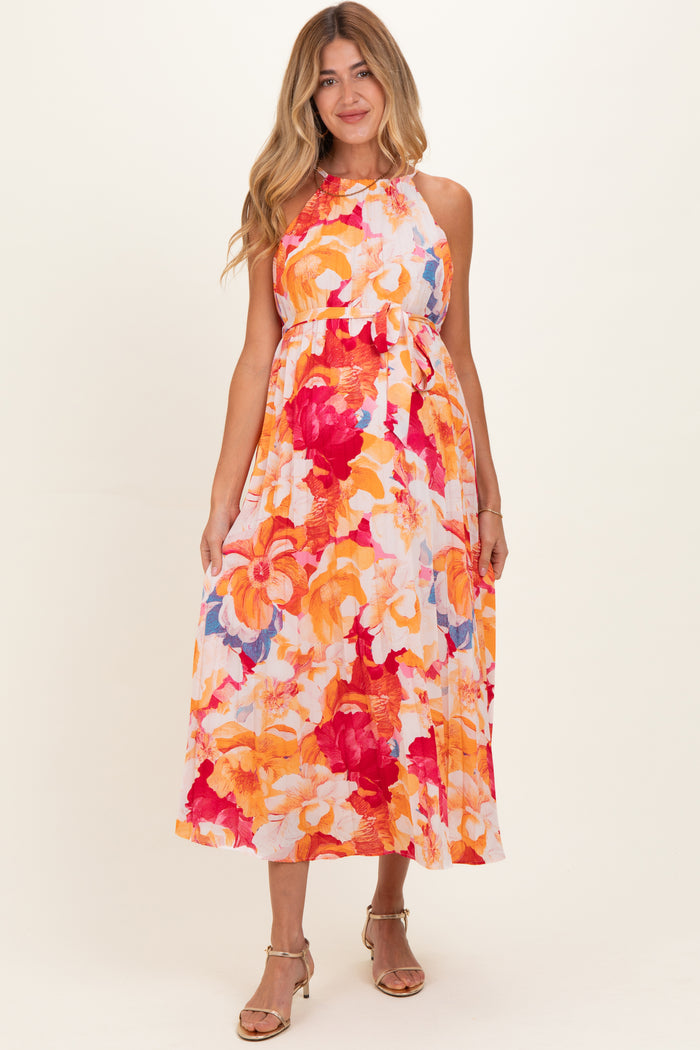 woman wearing a floral print maternity maxi dress in vibrant colors with a relaxed fit