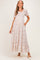 woman wearing a floral print maternity maxi dress with smocked bodice and puff sleeves