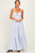 woman wearing a white and blue striped maxi dress with a keyhole detail and tiered skirt