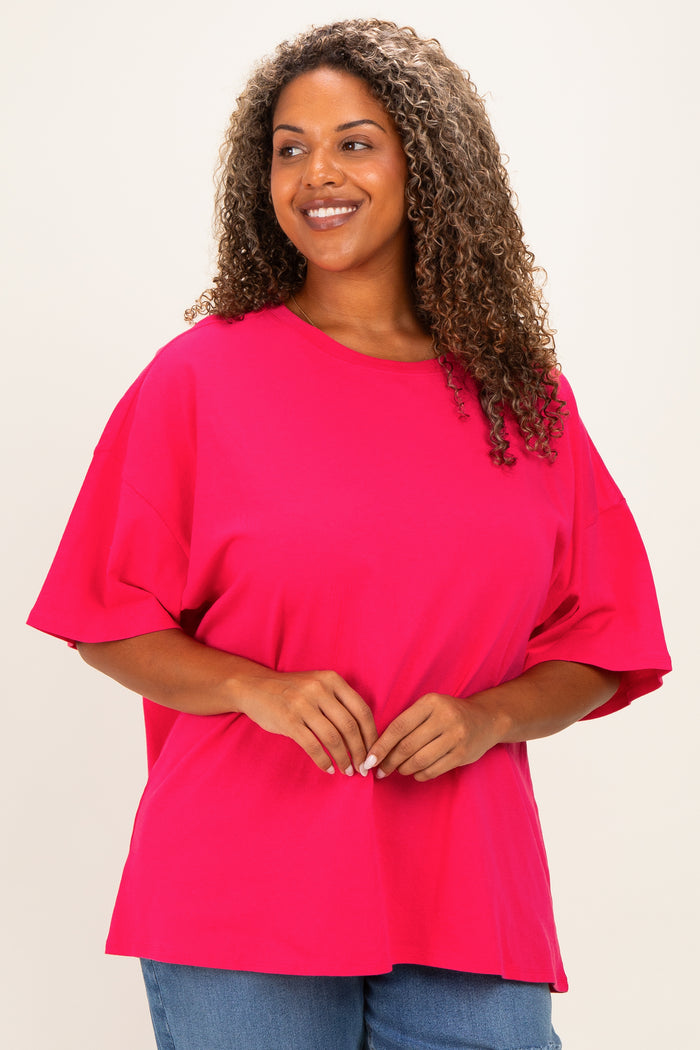 woman wearing a bright pink oversized t-shirt with short sleeves and a relaxed fit