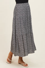 woman wearing a navy blue floral maxi skirt with a flared design and a comfortable fit