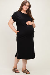 woman wearing a black short sleeve maternity dress with side pockets and a visible baby bump
