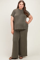 woman wearing an olive green ribbed maternity plus set with a short sleeve top and wide-leg pants