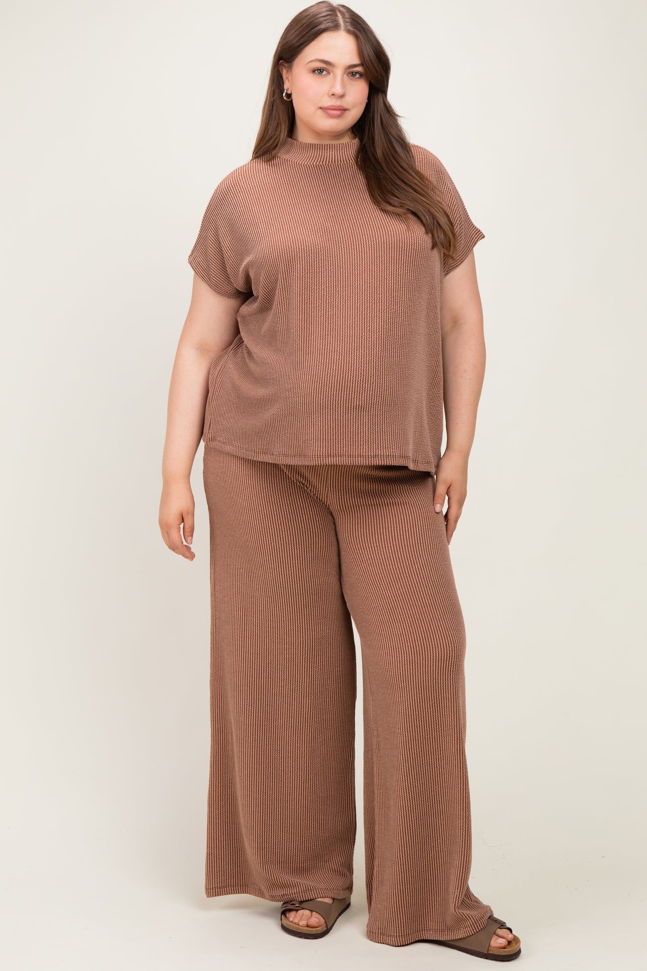 woman wearing a brown ribbed maternity plus lounge set with short sleeves and wide-leg pants