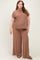 woman wearing a brown ribbed maternity plus lounge set with short sleeves and wide-leg pants