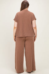 woman wearing a brown ribbed maternity plus lounge set, showing the back view of the top and wide-leg pants
